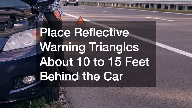 parked, damaged car with a reflective warning triangle placed behind it