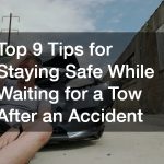 stressed man sitting in front of his damaged car